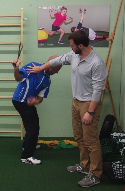 Jaacob Bowden helps a fellow golf professional during a swing speed training clinic for the Swiss PGA in 2013