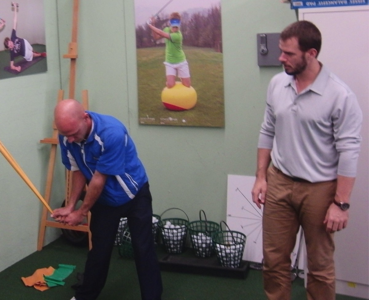 Jaacob Bowden works with a Swiss PGA pro on his swing speed using band isometrics